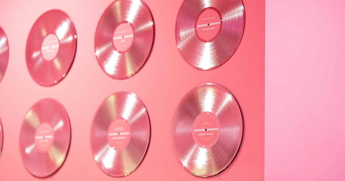 A pink wall features multiple platinum records as decoration