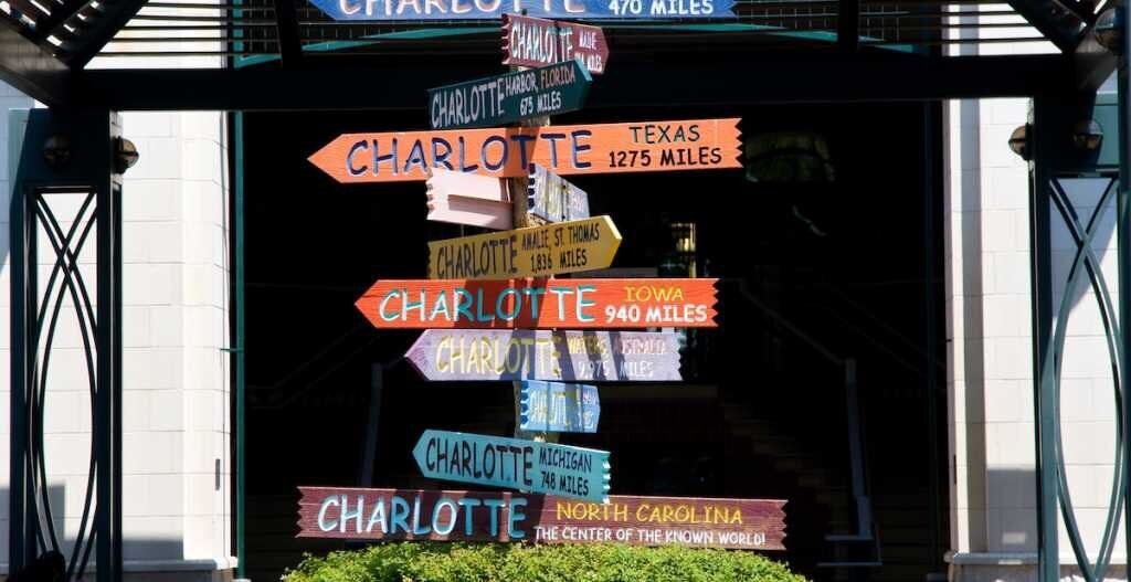 Many signs pointing in different directions that all read "Charlotte"
