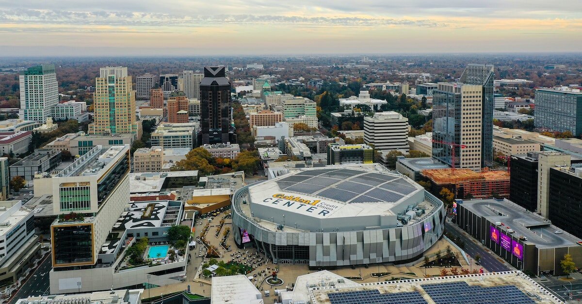 a sports arena in Sacramento, surrounded by downtown buildings