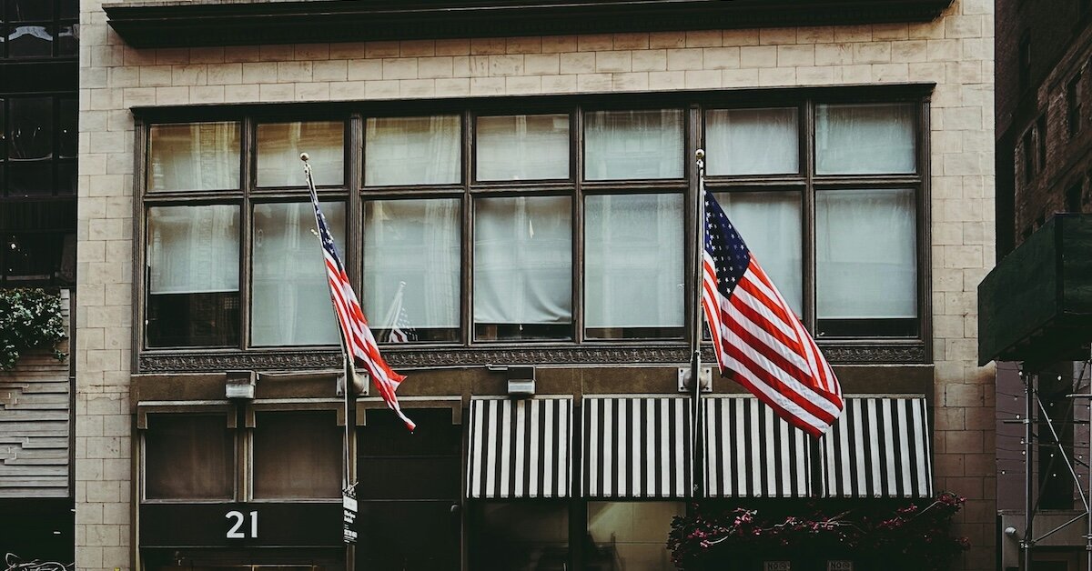 a commerical real estate building with American Flags out front