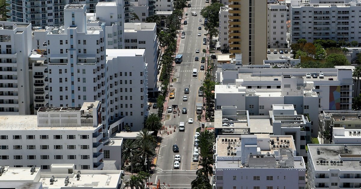  A crowded city street surrounded by commercial buildings