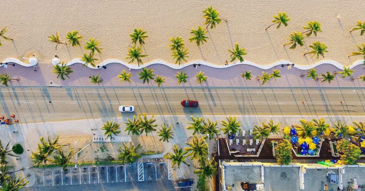 An overhead view of a beach side road with cars driving in Miami