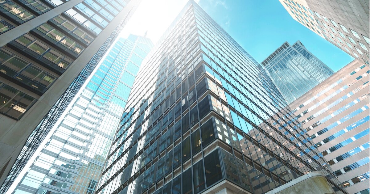 tall, metallic blue buildings reflect the sky