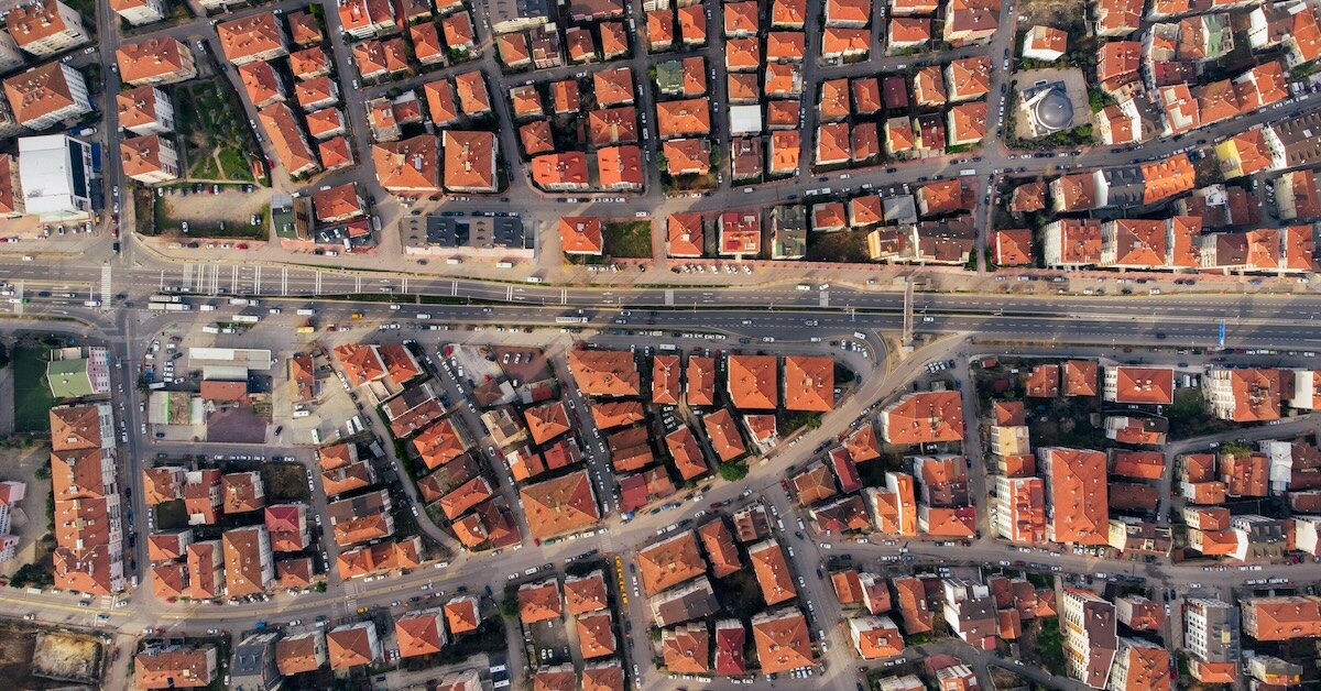 An overhead shot of a suburban neighborhood with matching terracotta roofs