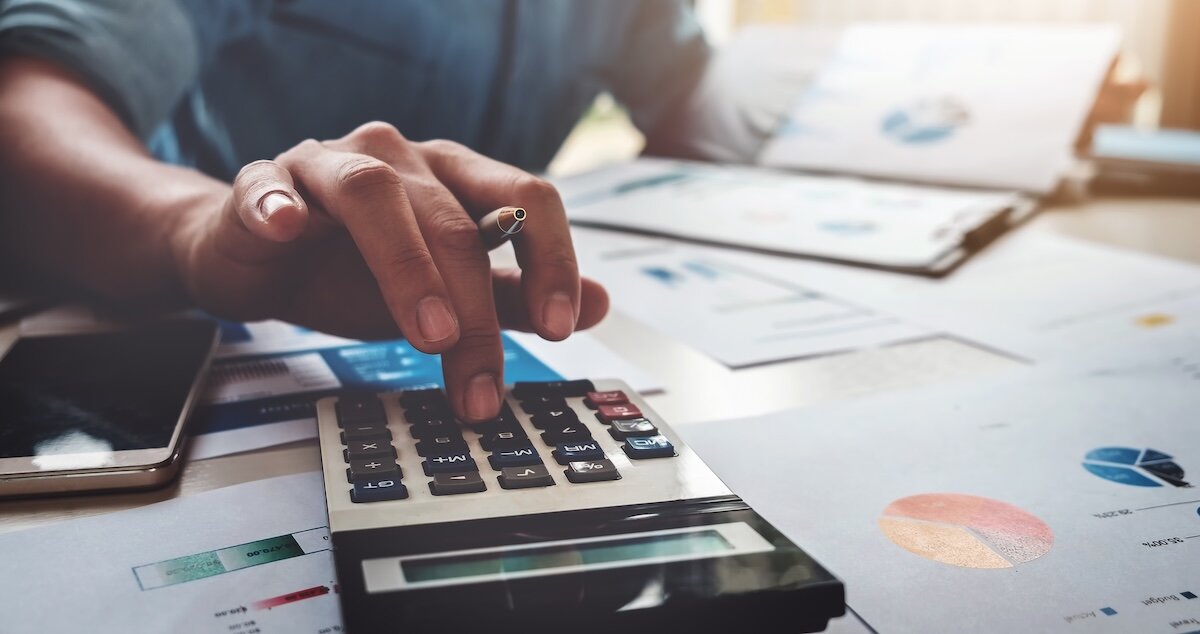 a man using a calculator to make financial decisions