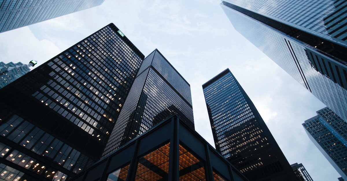 dark skyscrapers standing against a cloudy sky