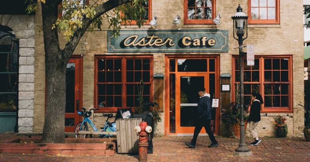 A coffee shop with pedestrians walking by in Minneapolis