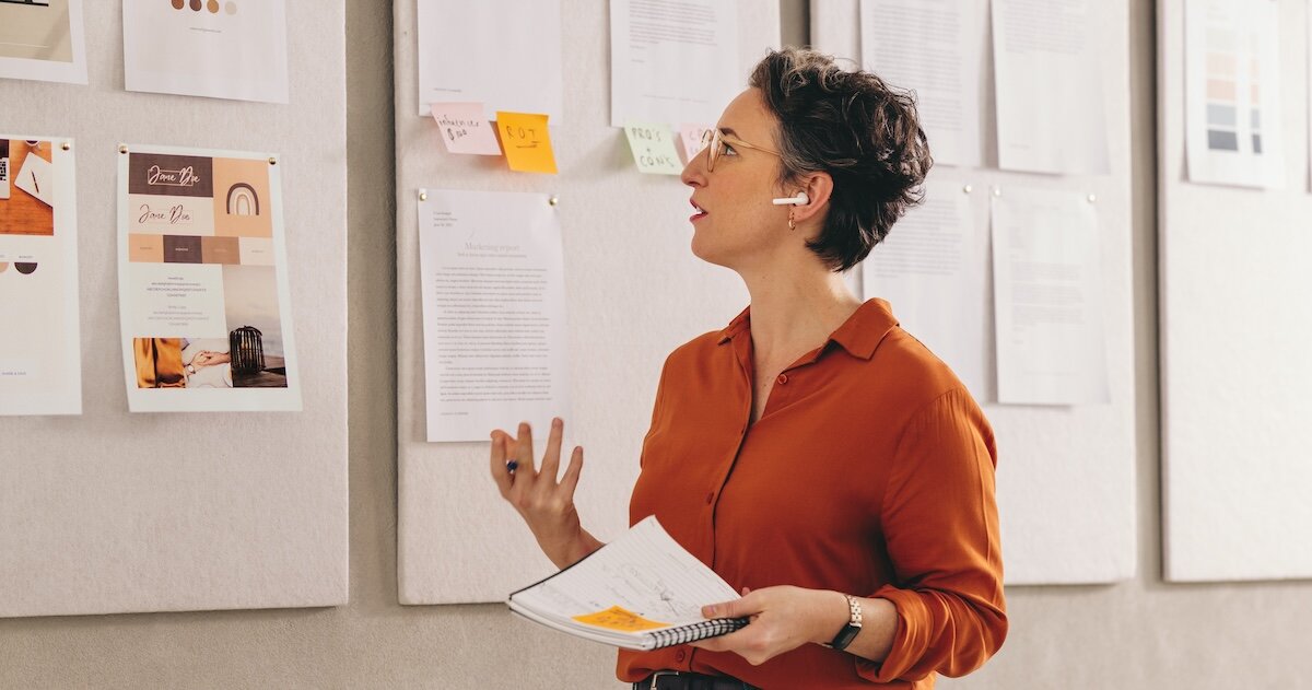 A woman on the phone working on a pitch to raise a syndication fund for real estate investing