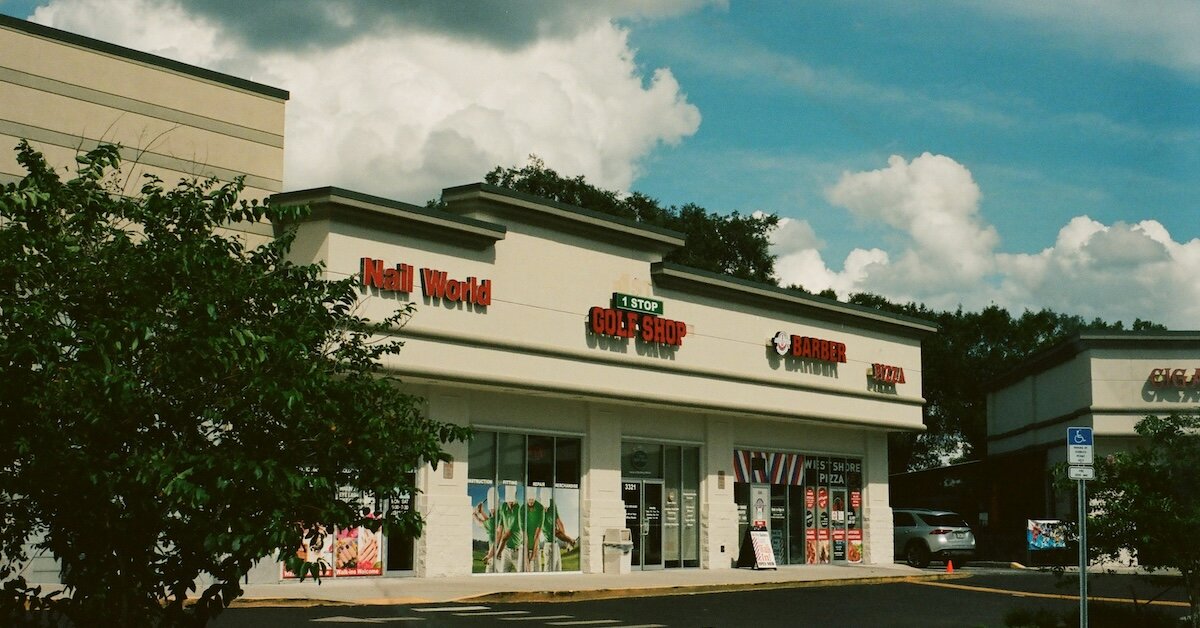 outside of a retail strip center with shops leased up