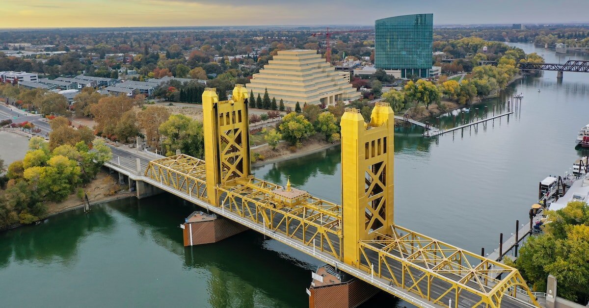 a yellow bridge crossing the Sacramento river in Sacramento