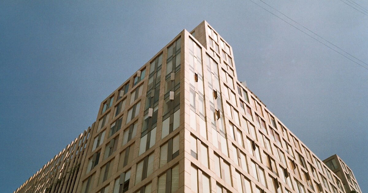 The corner of an older skyscraper against a gray sky
