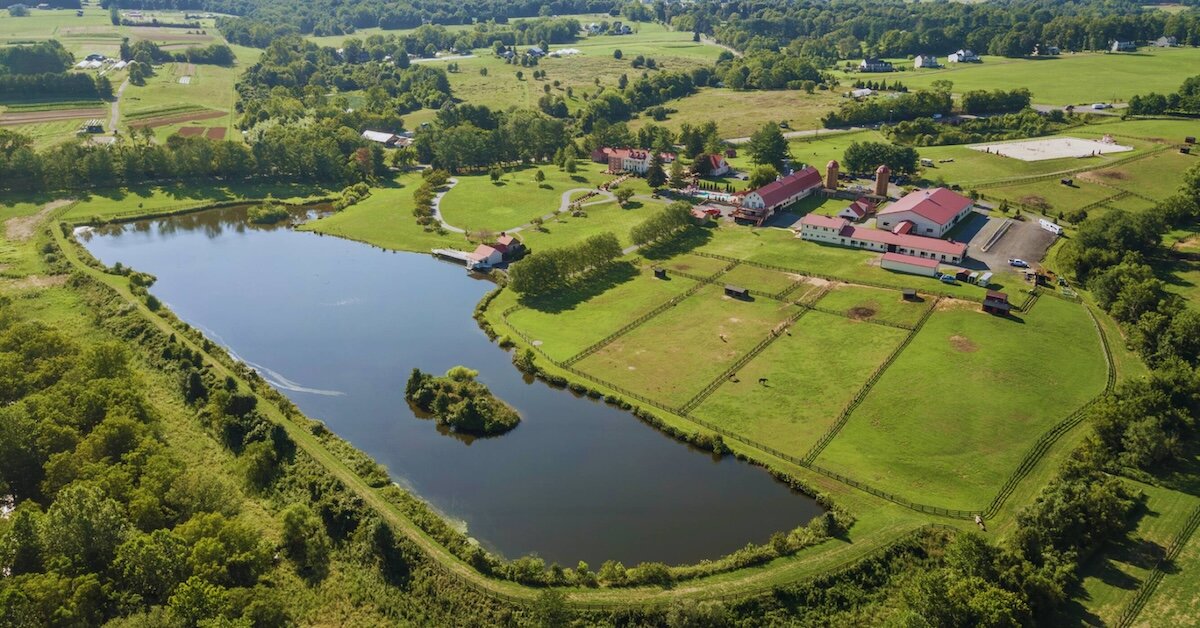A drone photo of Wheatland Farm surrounded by green acreage