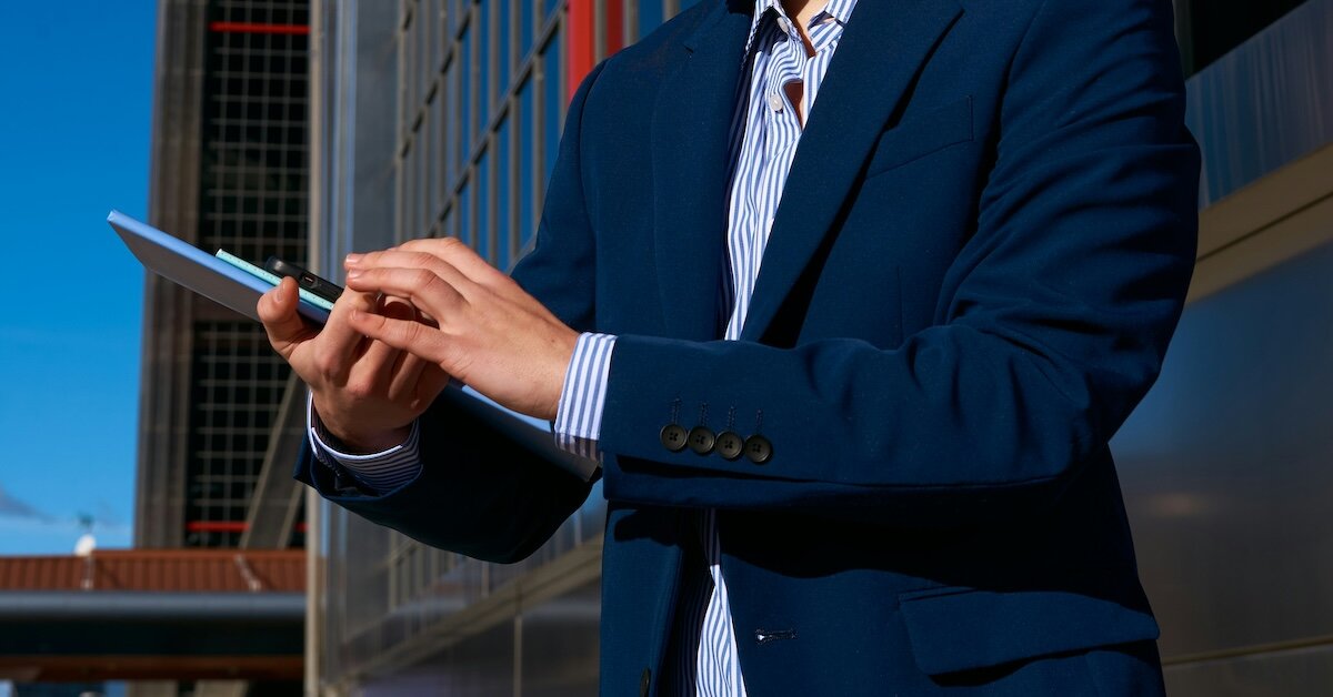 a broker tapping something on his phone