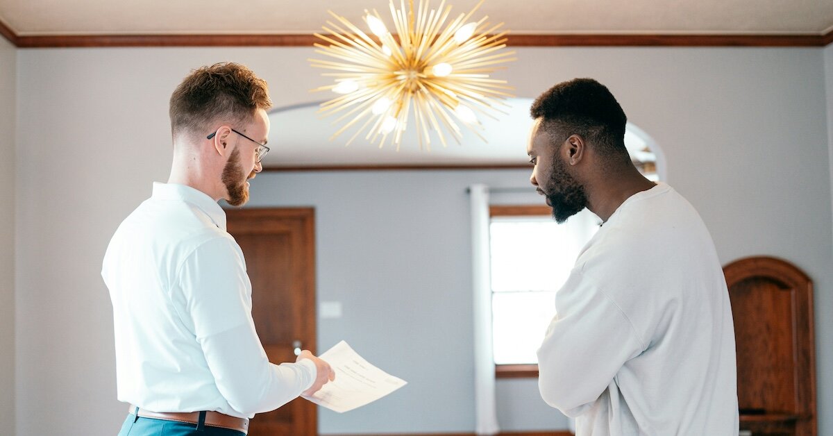 Two brokers reviewing paperwork in an empty office