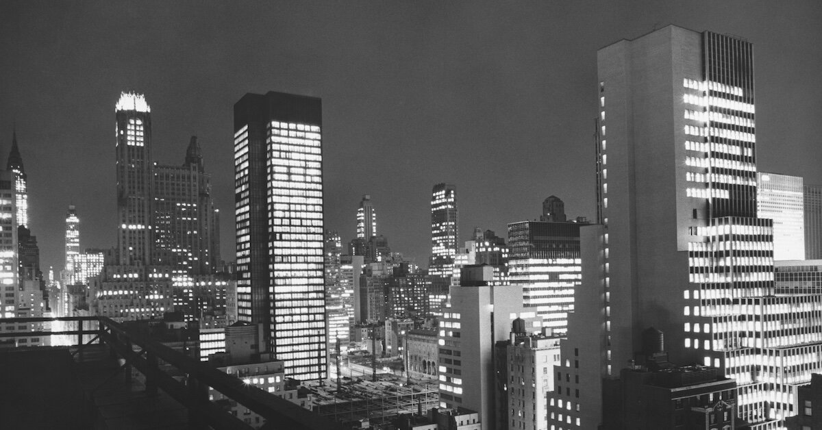 A black and white photo of new york city's skyscrapers at night