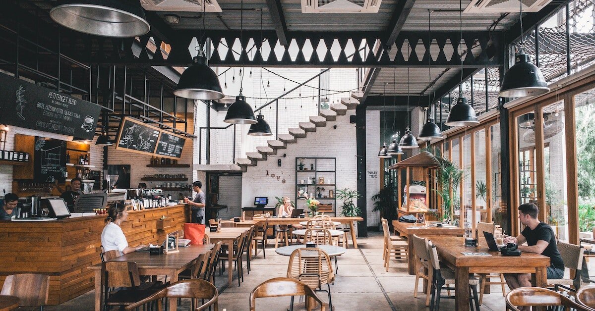 The interior of a busy coffee shop that's one tenant in a multi-use building.
