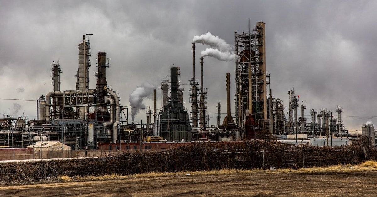A factory sits against a dark gray sky