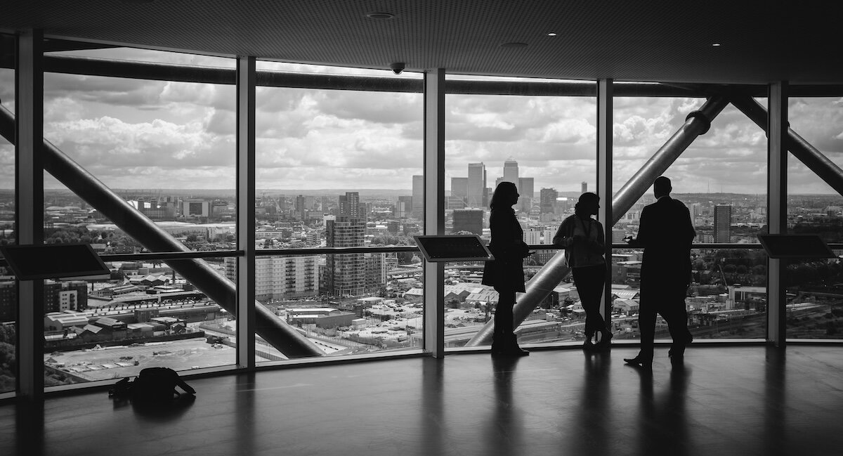 brokers planning at the top floor of a skyrise office building