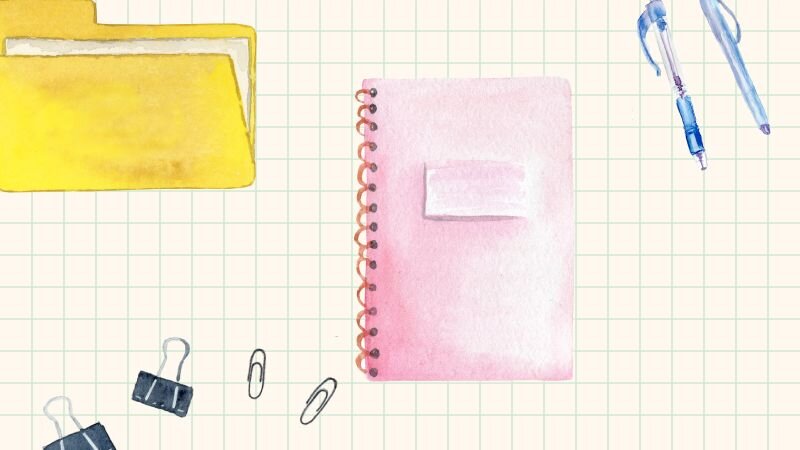 A watercolor illustration of a notebook, pens, paperclips, and other desktop therapist accessories.