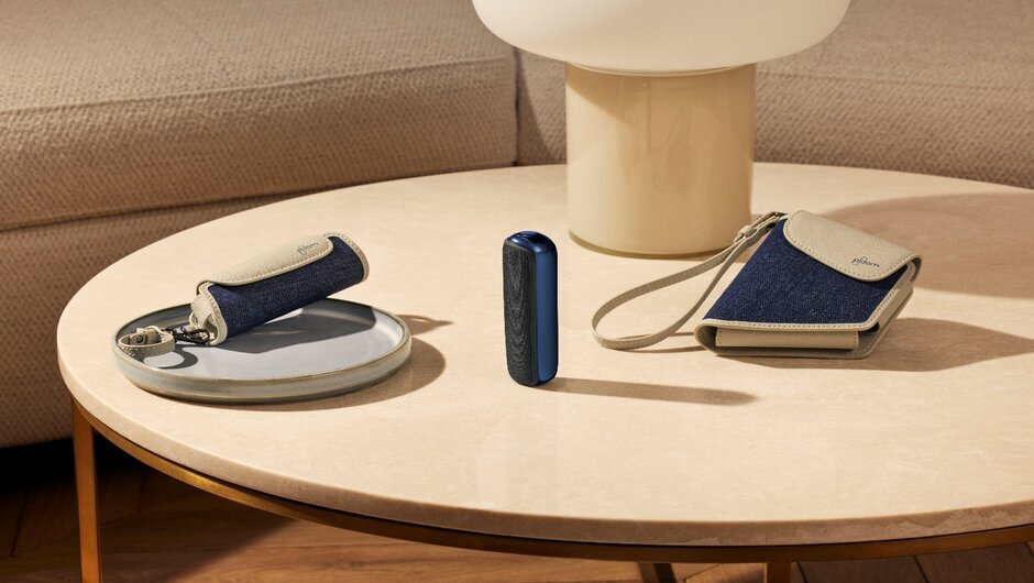 Modern beige table with Ploom AURA device and denim and beige style cases
