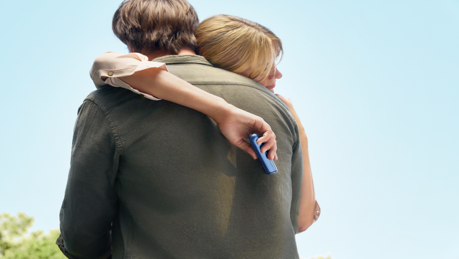 Couple enjoying a romantic moment under flowering trees.