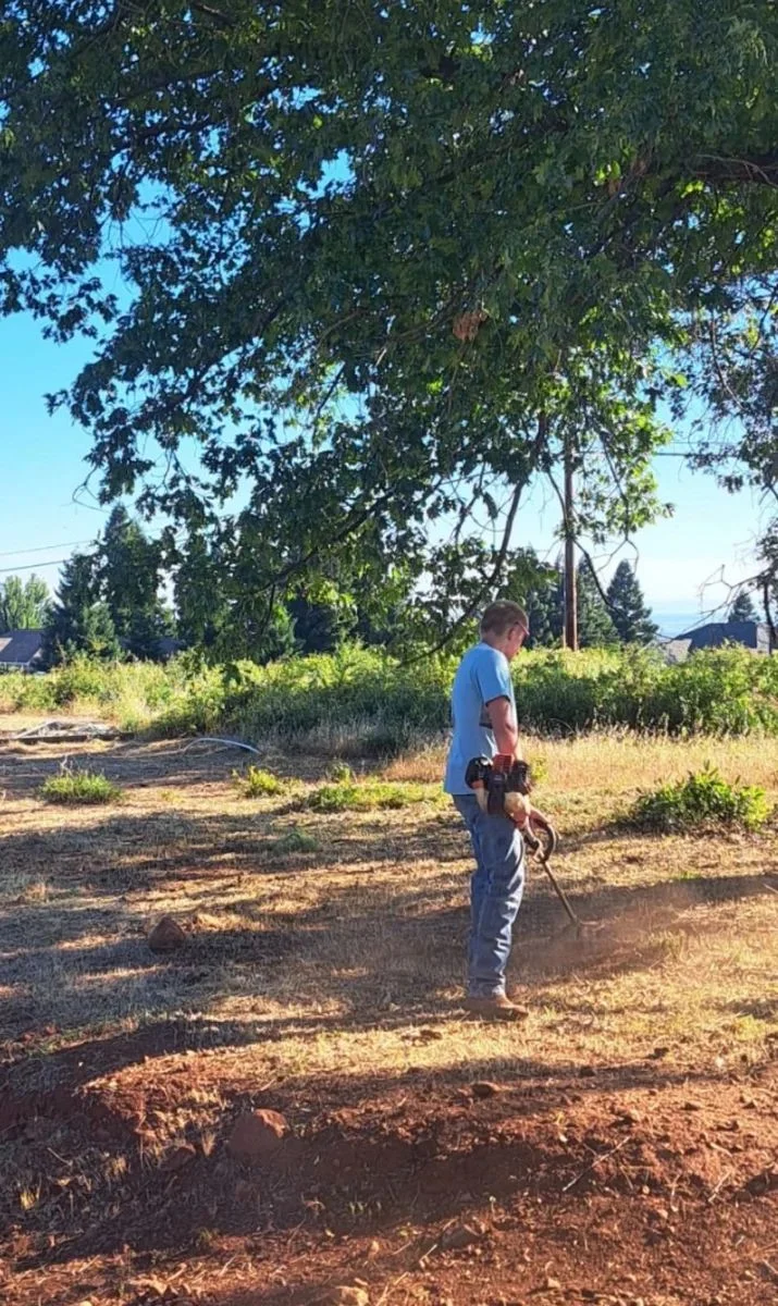 Weed Eating in progress on a residential property