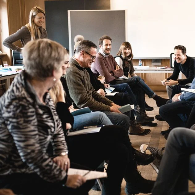 A group of veterinary professionals smiling during a workshop