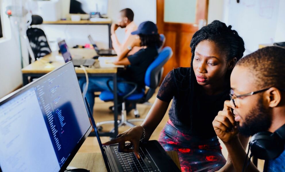 nigerian man and woman looking a computer screen