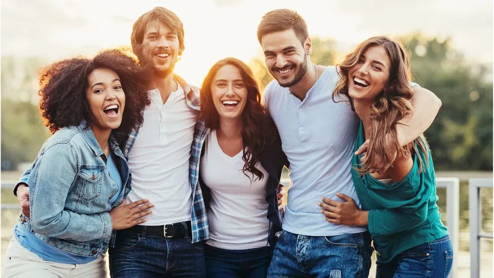 happy friends against a sunset