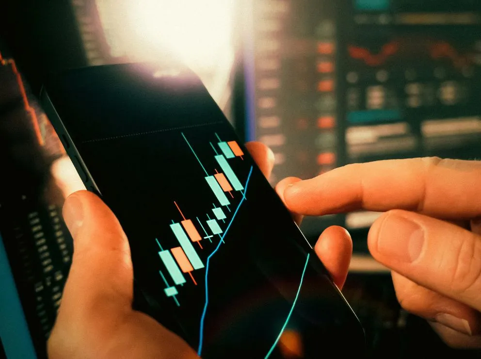 close up of candlestick charts on a phone screen