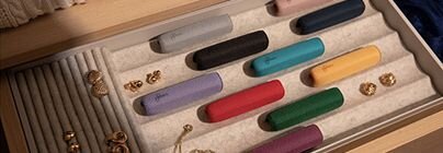 Multiple colorful Ploom AURA devices in tray-4
