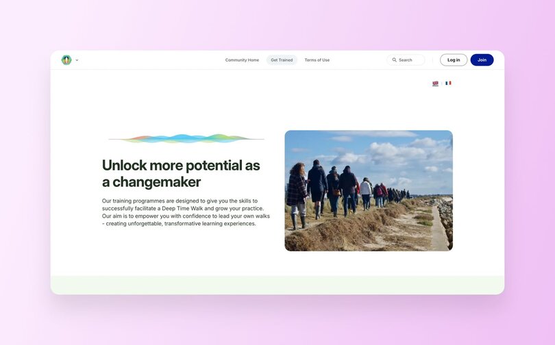 Deep Time Walk homepage with headline "Unlock more potential as a changemaker." Features photo of people walking along coastal path. Text describes training programs designed to give skills for facilitating Deep Time Walks, empowering confidence to lead transformative learning experiences. Mountain landscape illustration accent at top.