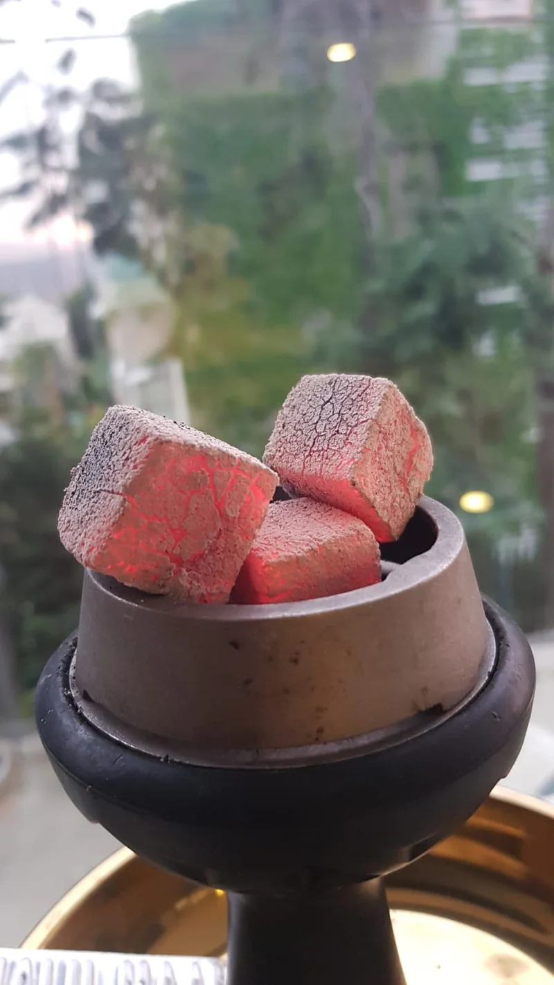 Go Chicha coconut charcoal cubes with perfect red glow in clay bowl