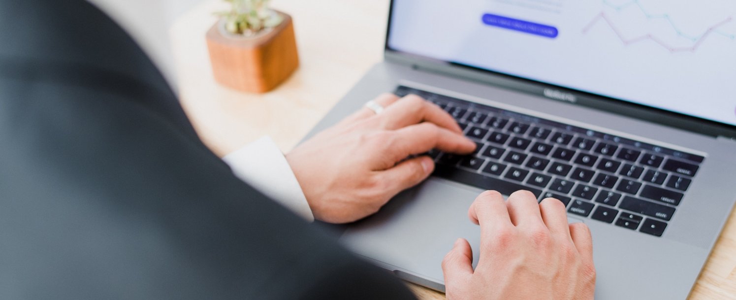 White person writing on the computer 