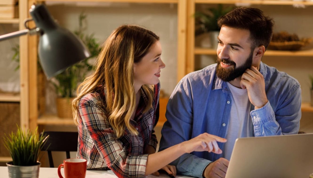 Two people collaborate at a computer