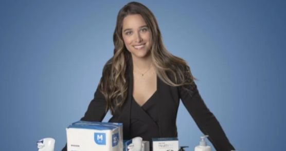 Two people sit while clasping hands