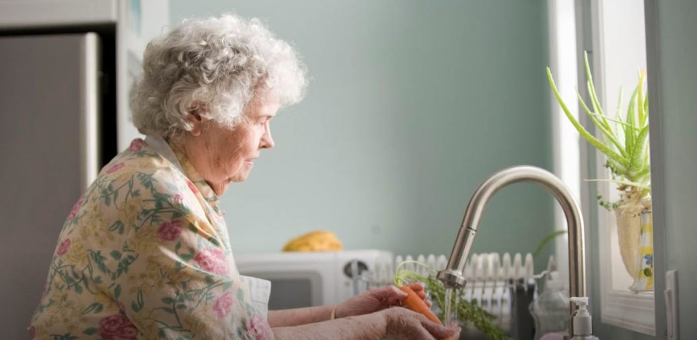 A woman washes some carrots