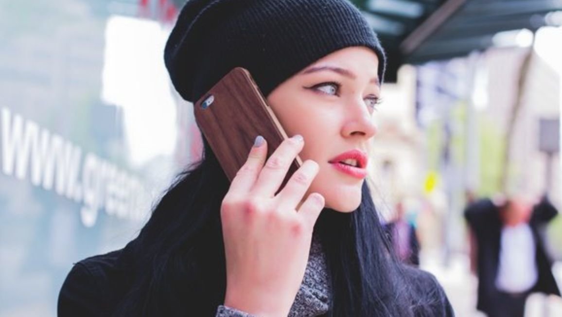 A woman talks on a cell phone