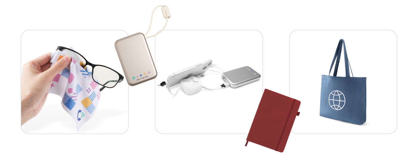 A collection of Wayo custom products, including a branded microfiber cloth cleaning eyeglasses, a beige portable power bank with logo, a compact tech organizer with charging cables, a red hardcover notebook, and a blue canvas tote bag featuring a globe icon.