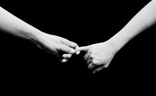 black and white image of two holding hands