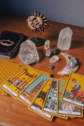 tarot cards fanned out on a table with gems