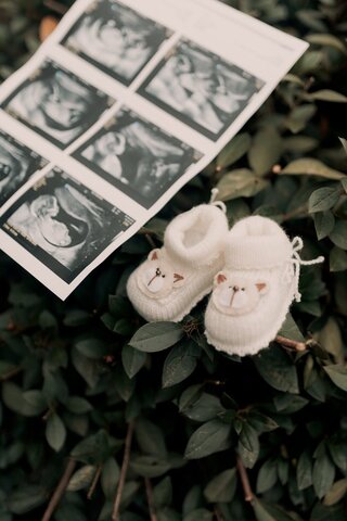 images of an ultrasound next to white baby booties
