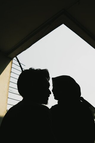 two people silhouetted about to kiss