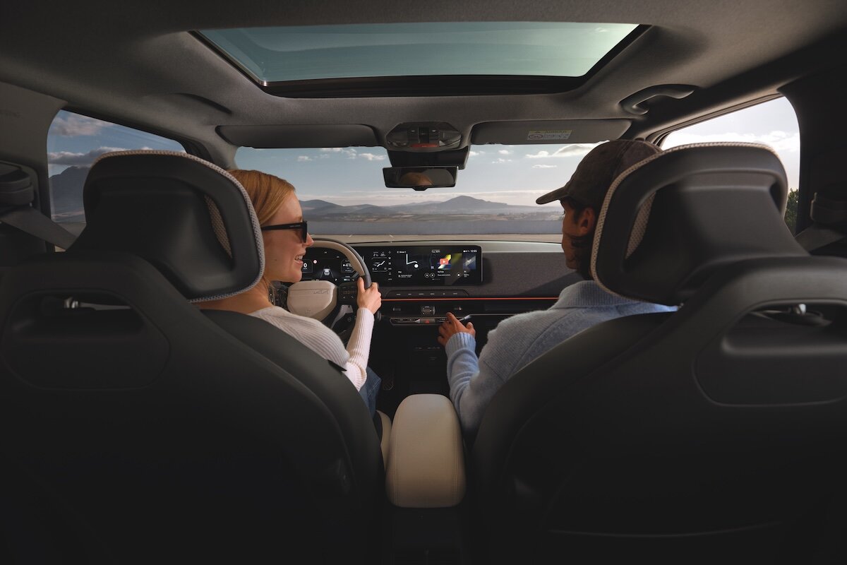 2026 Kia EV2 showing dashboard with couple driving and smiling
