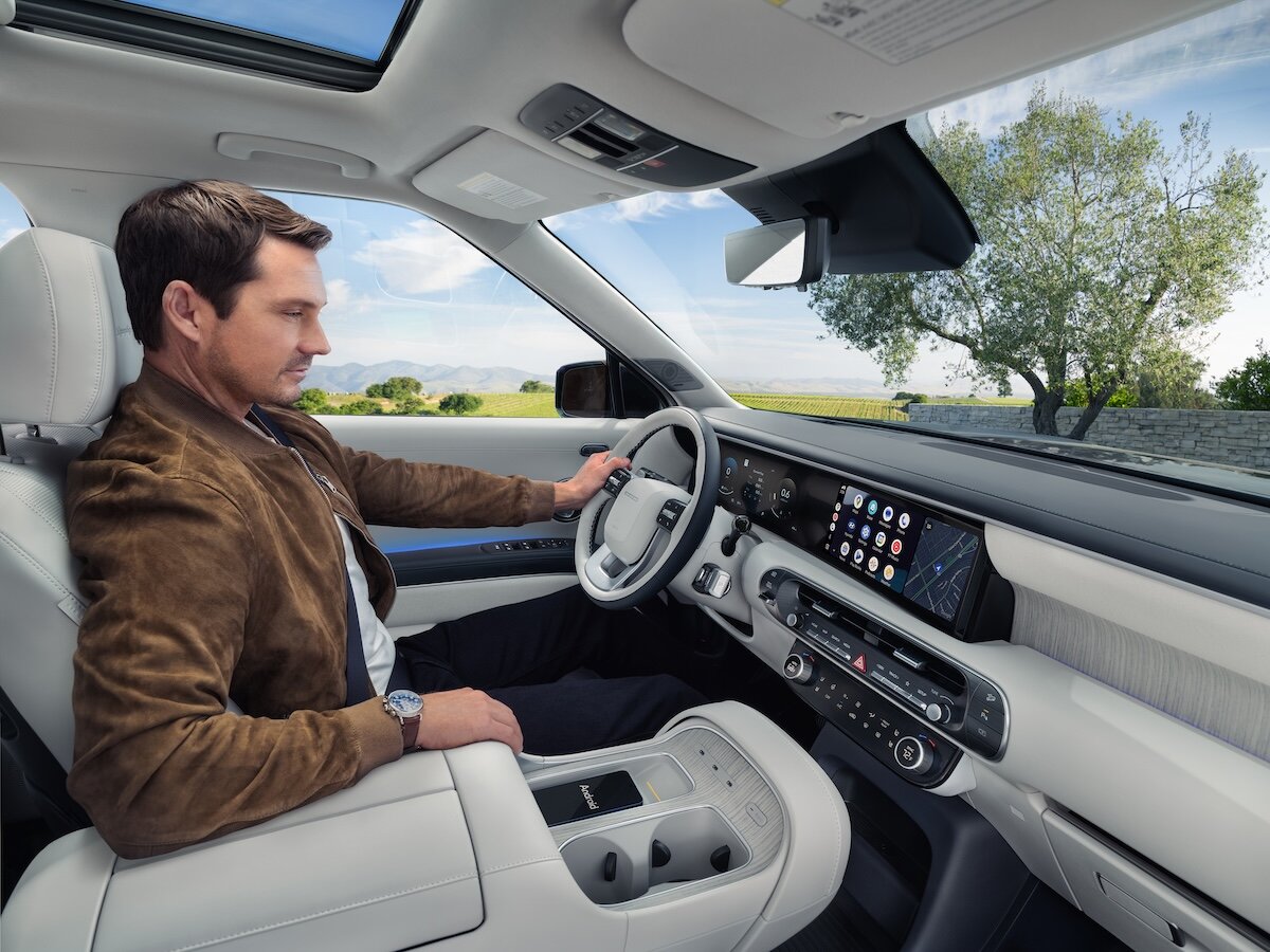 2026 Hyundai Palisade man in driver's seat looking at touchscreens