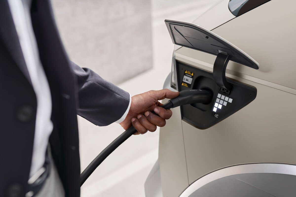 2026 Hyundai IONIQ 5 person plugging charging cable into port