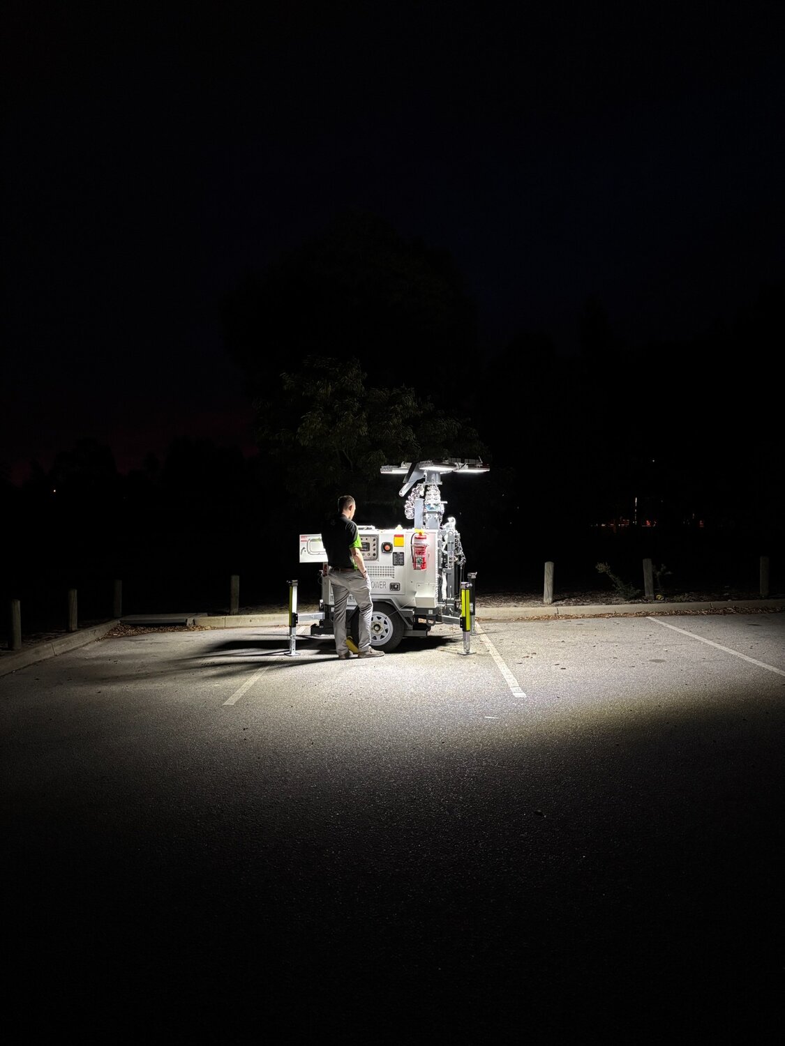 Hybrid LED light tower providing portable lighting for a worksite at night.