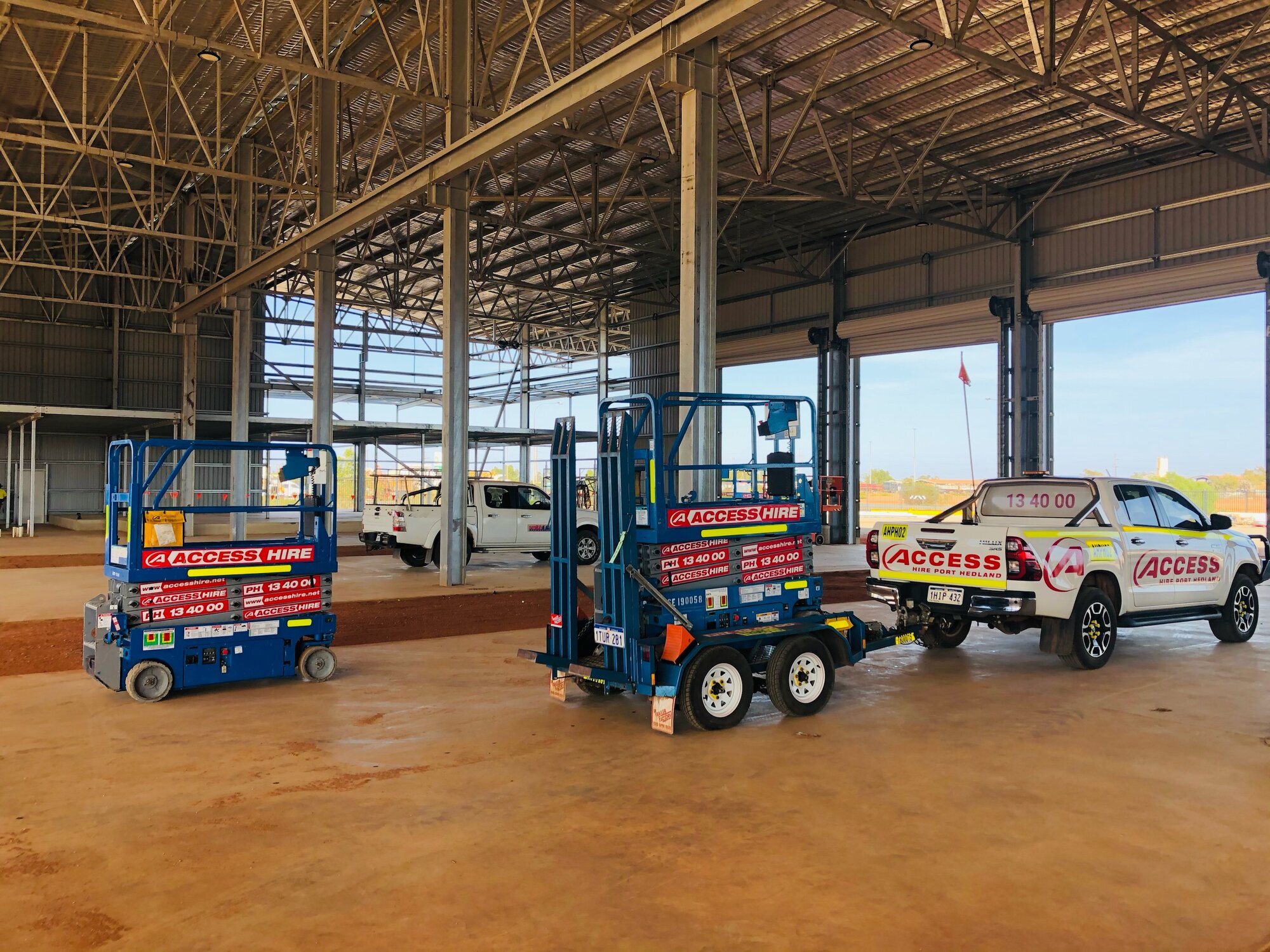 Access Hire scissor lifts being delivered and positioned inside an industrial facility in Port Hedland, Western Australia.