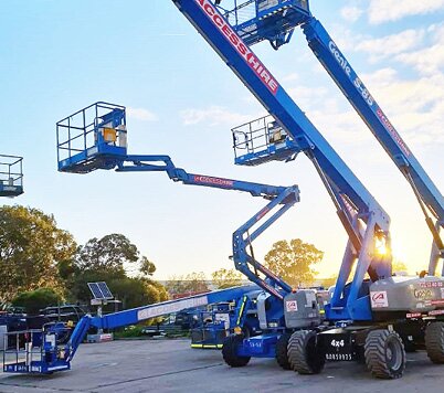 Genie boom lifts displayed in the Access Hire Adelaide equipment yard at sunset