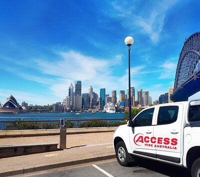 Access Hire service vehicle overlooking Sydney Harbour with the Sydney Opera House and Harbour Bridge in the background